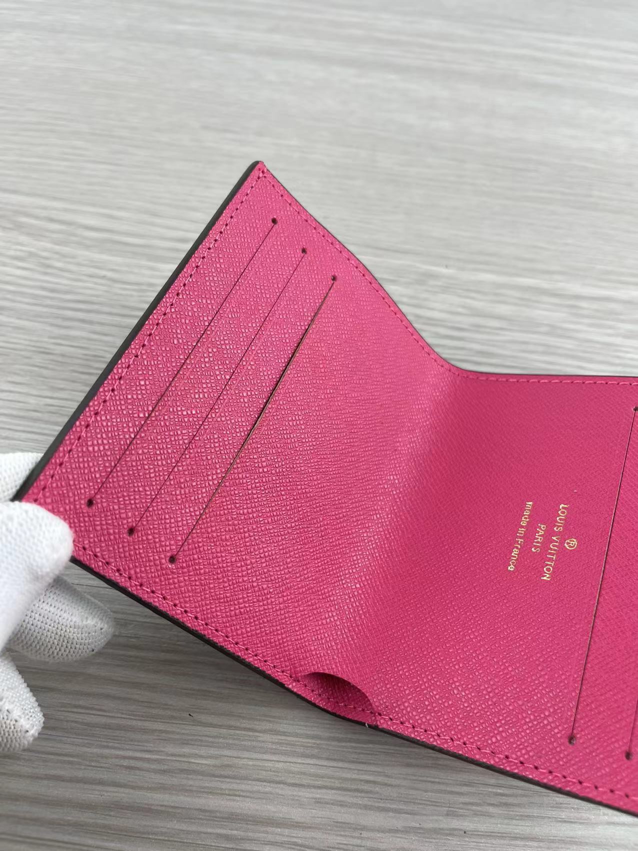 Pink leather card holder with cards inserted