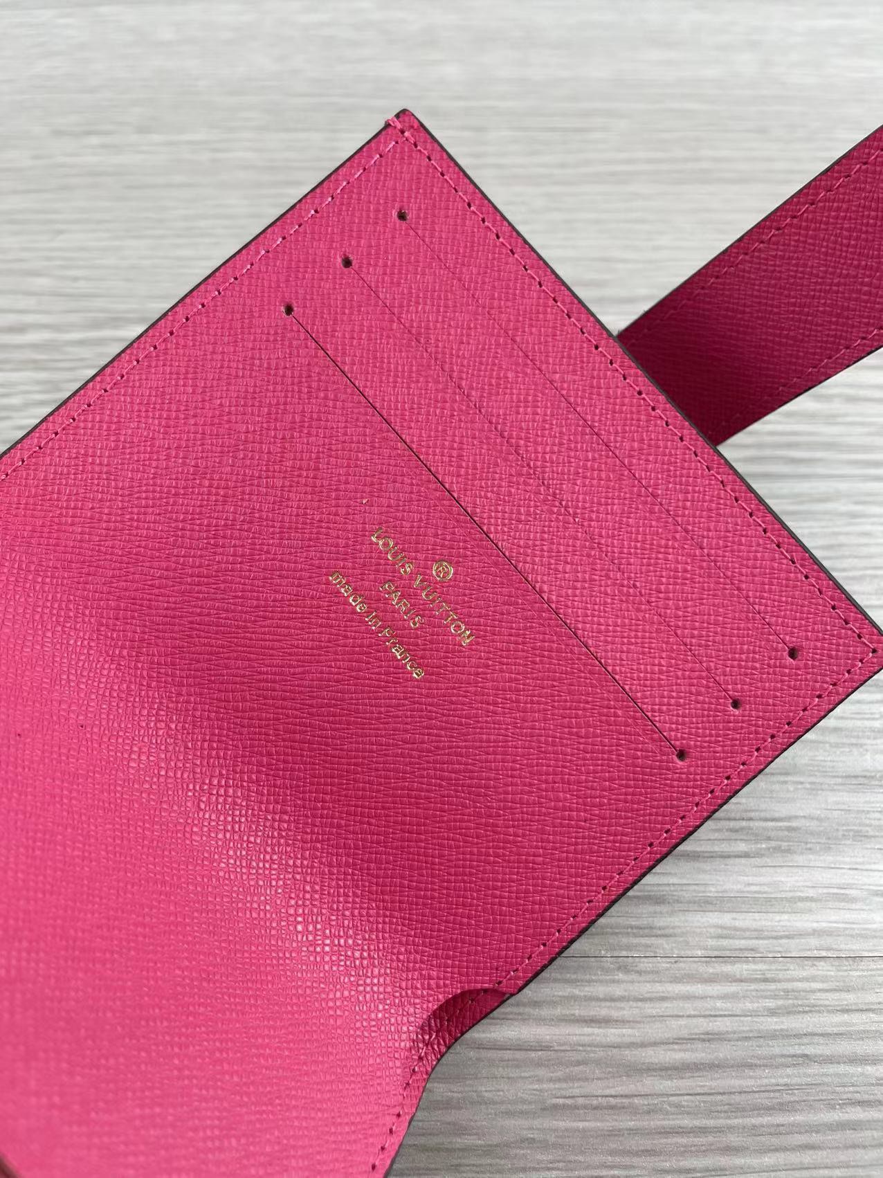 Close-up of stitching on pink leather card holder