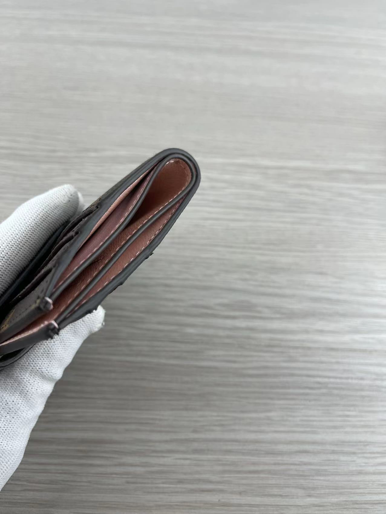 Pink leather card holder stitching detail