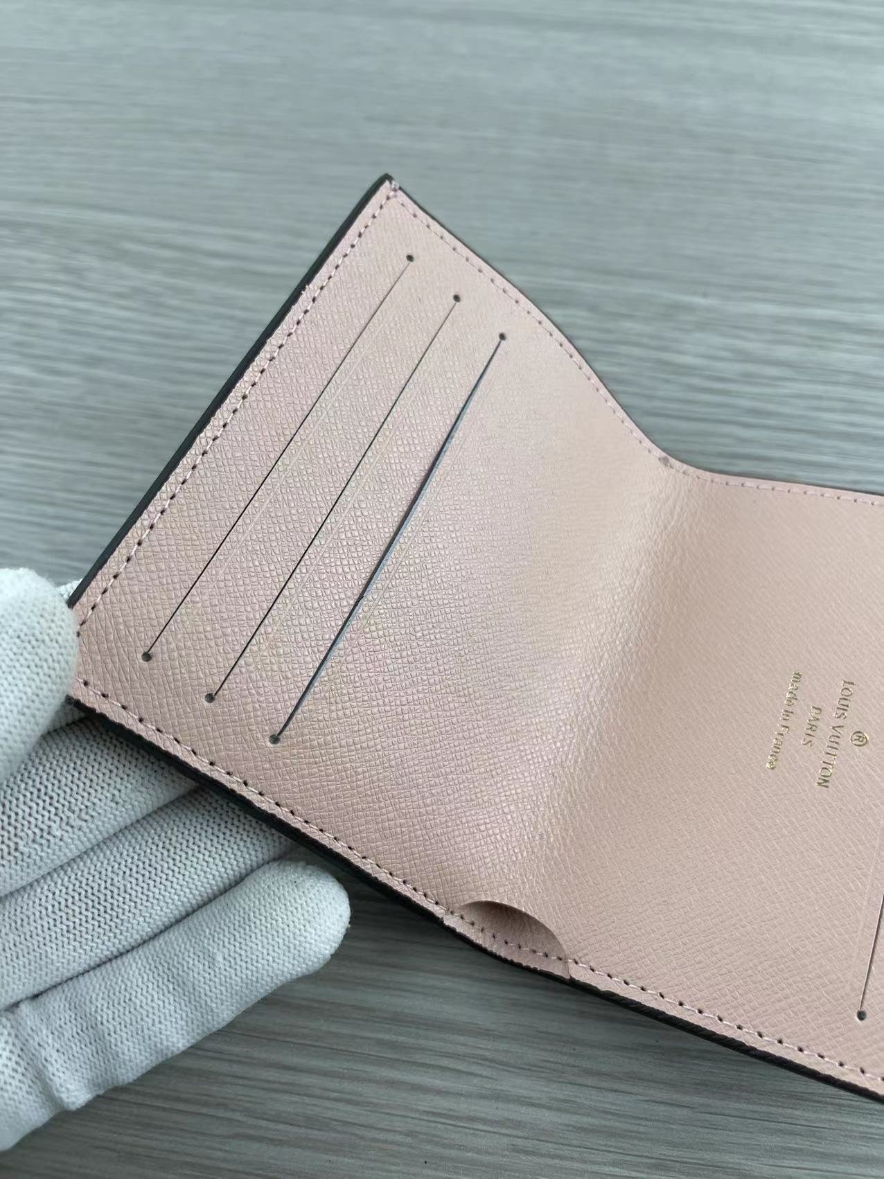 Pink leather card holder in hand