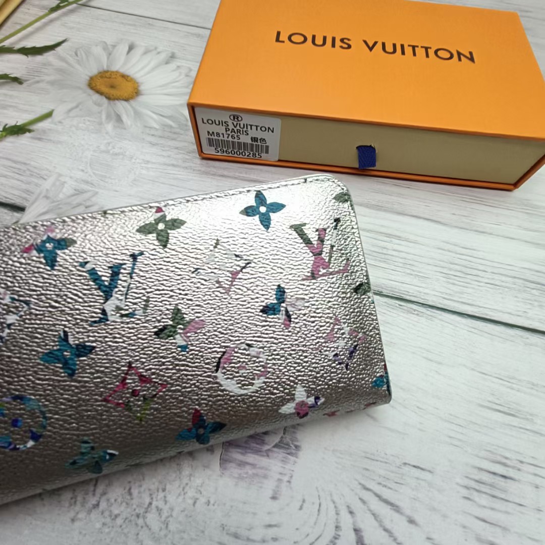 A person holding a leather bifold wallet