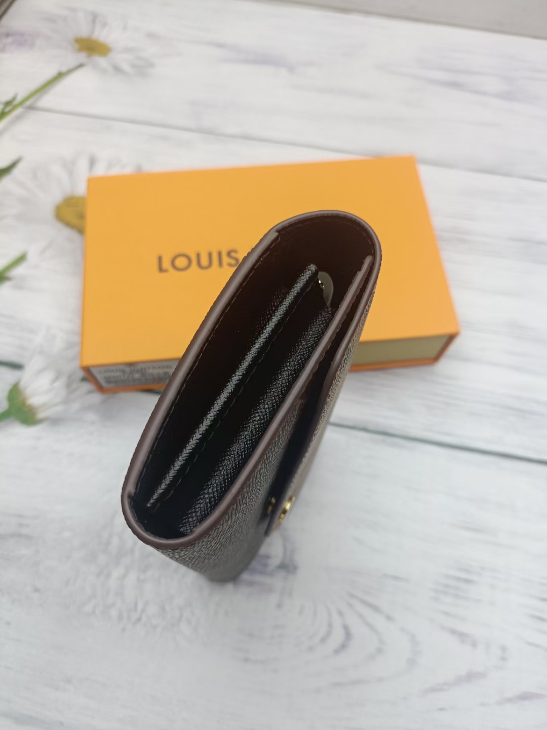 Leather wallet in-hand showing size reference