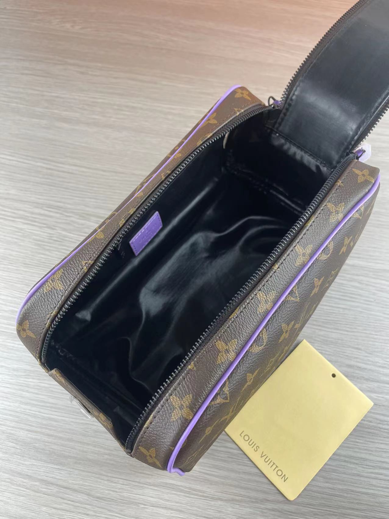 Close-up of purple leather wash bag details