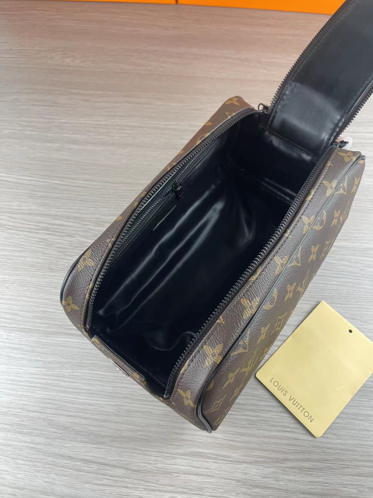 Black leather wash bag in use