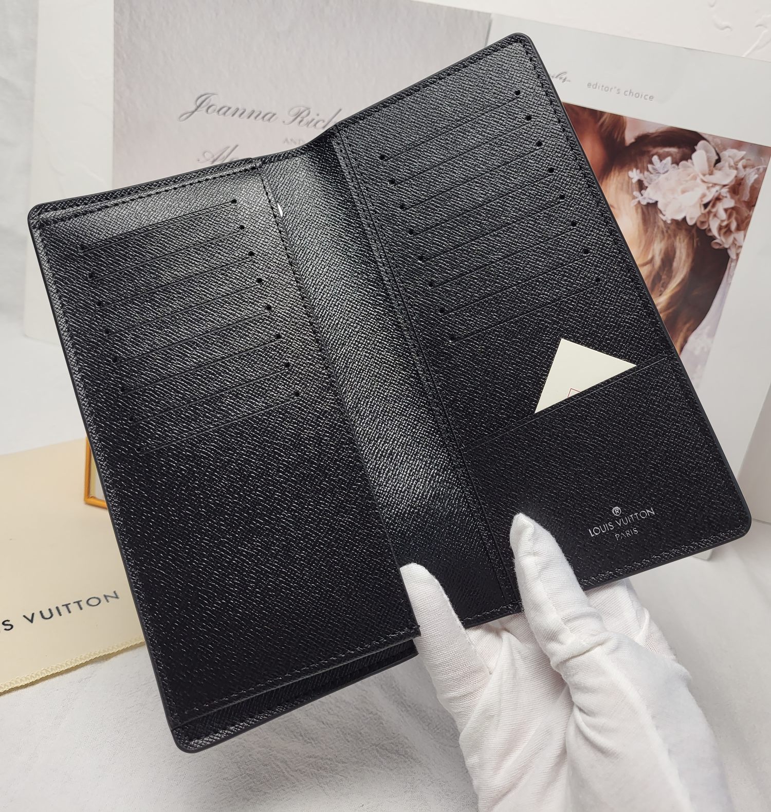 Leather bifold wallet in hand.