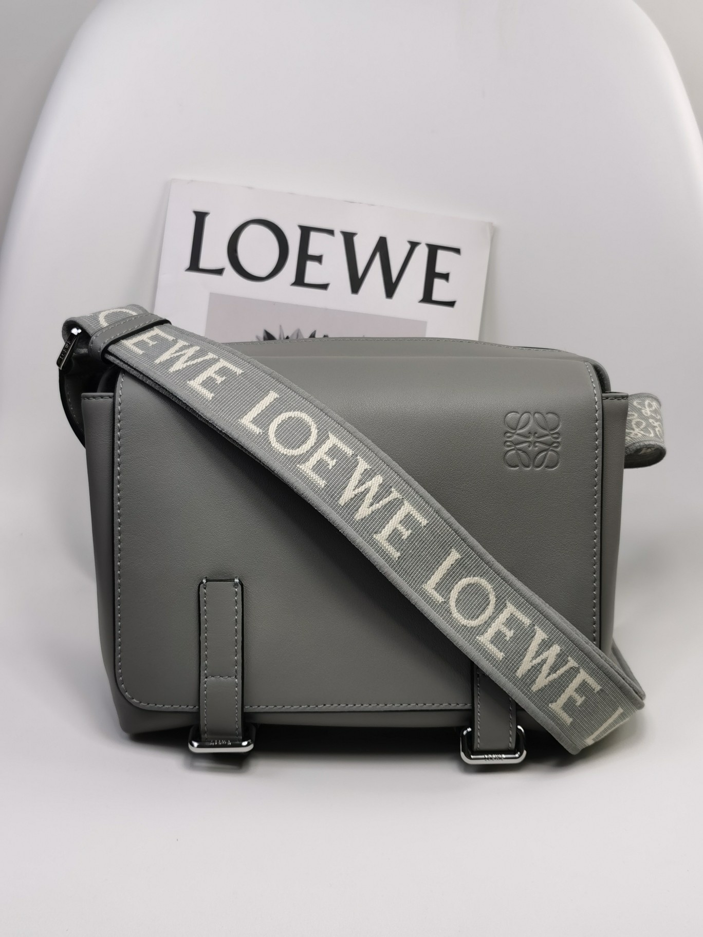 NO:338788,The new Loewe XS Postman Bag A74 Pearl Gray: Size 23-18-9cm military messenger classic messenger bag. This model changes the classic postman bag method in the past. It has designed a zipper main compartment. The front is matched with a buckle to open and private items, which is more user-friendly. The overall feeling is more flawless. Built-in two card slots, cigarettes, mobile phones, power bank, wallet, storage ideal index 5 stars. Imported lychee pattern calfskin and soft fine-line leather calfskin on the back, and adjusted cotton webbing shoulder straps, which doubles the comfort! , special Loewe, loewe, loewe, cowhide19860909特级 Loewe 新款XS邮差包 A74 珍珠灰 :尺寸23-18-9cm military messenger经典信使包 ,此款一改过去经典邮差包做法,设计了拉链主隔层,前部搭配搭扣打开方式放隐私物品,安全之余更加人性化.整體感覺更無懈可击.内置两卡槽,香烟,手机,充电宝,钱夹,收纳理想指数5颗星 采用进口荔枝纹小牛皮搭配背部柔软细纹皮小牛皮,调节的棉质织带肩带,使用舒适感倍增！,特级罗意威,loewe,loewe,cowhide,Bag