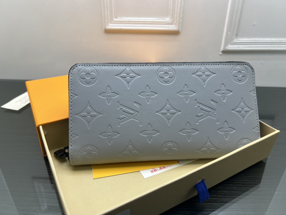 The leather wallet open with cards and cash