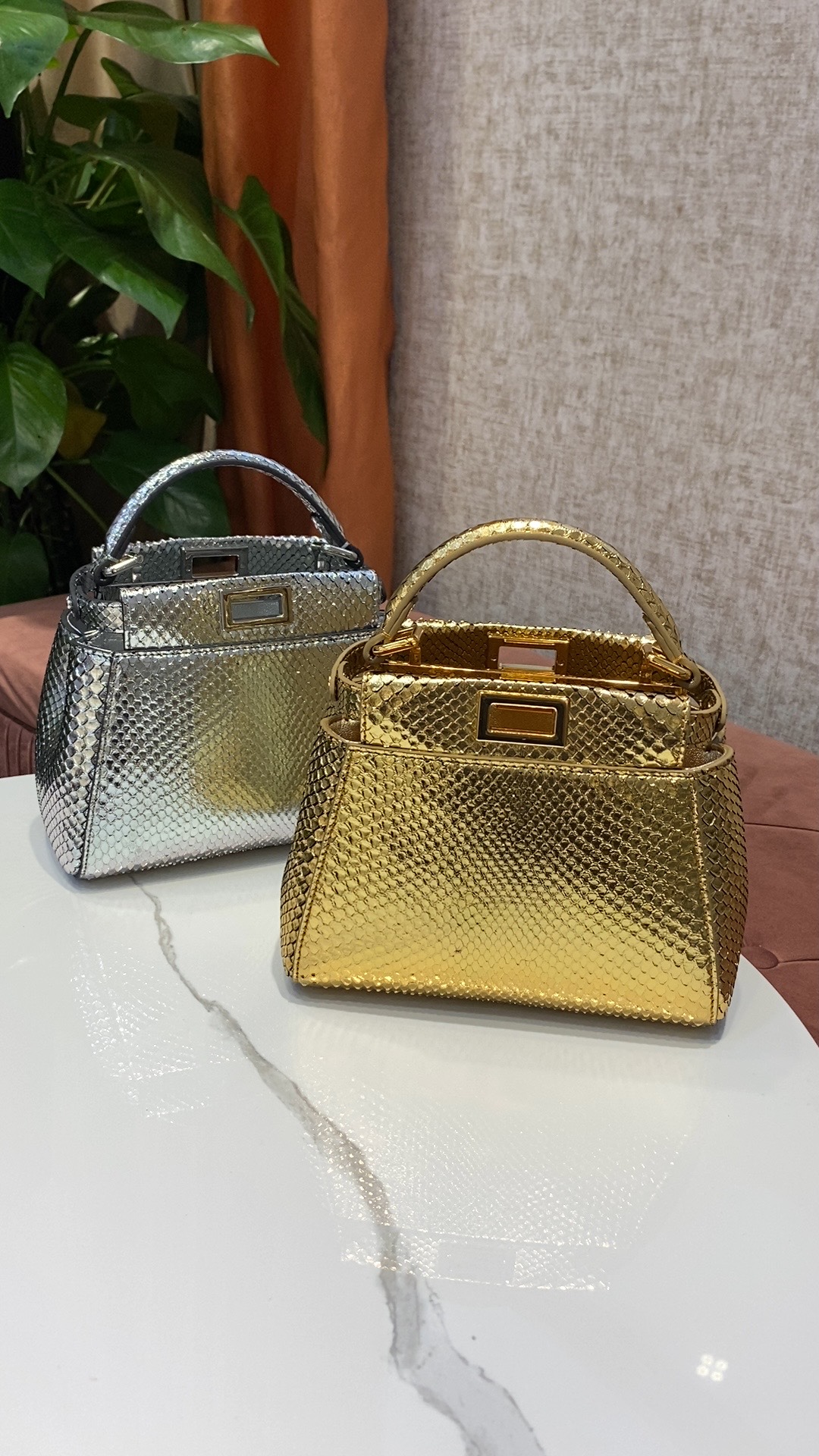 Made from sparkling python material imported from the Philippines, Fendi's new small peekaboo has internal pockets and iconic twist lock, single