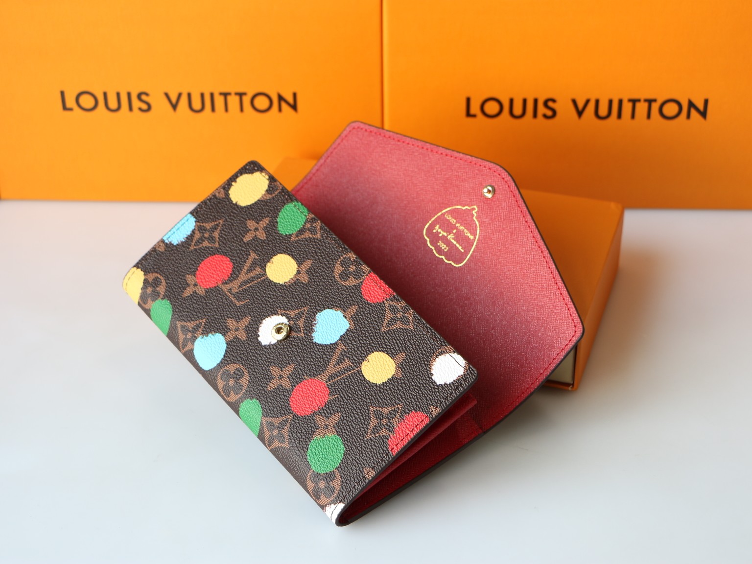 The leather wallet open with cards and cash