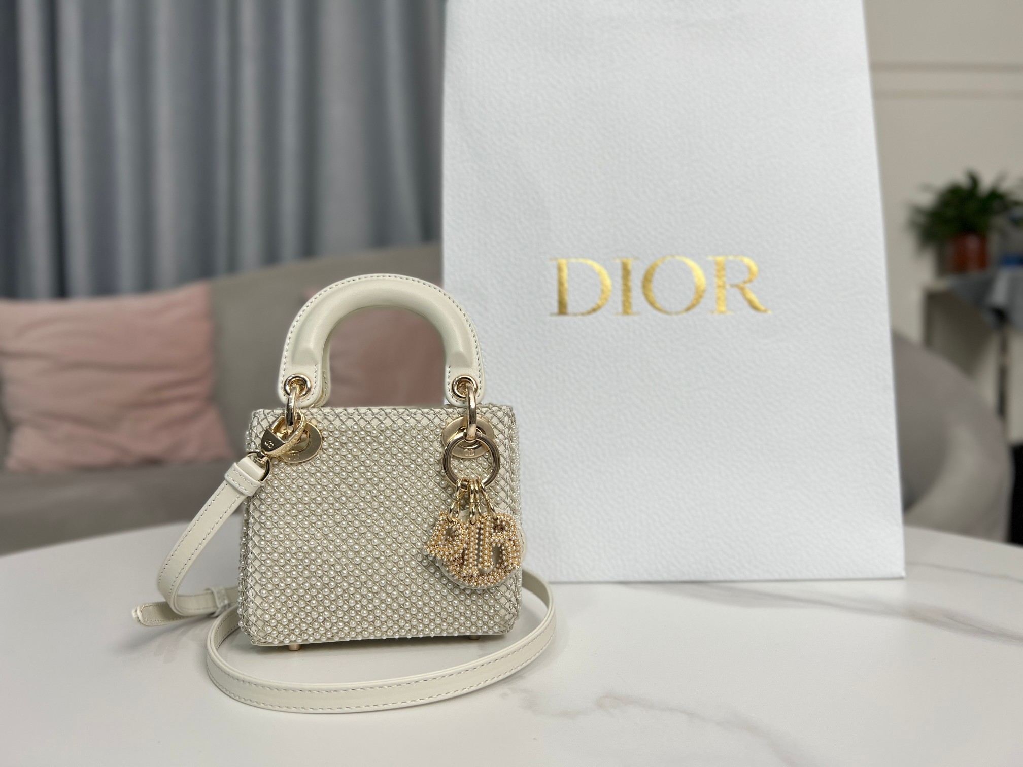 Lady Dior's ultra-mini embroidered limited edition pearls are lined with imported sheep tendons. They are carefully made by hand using milky whit