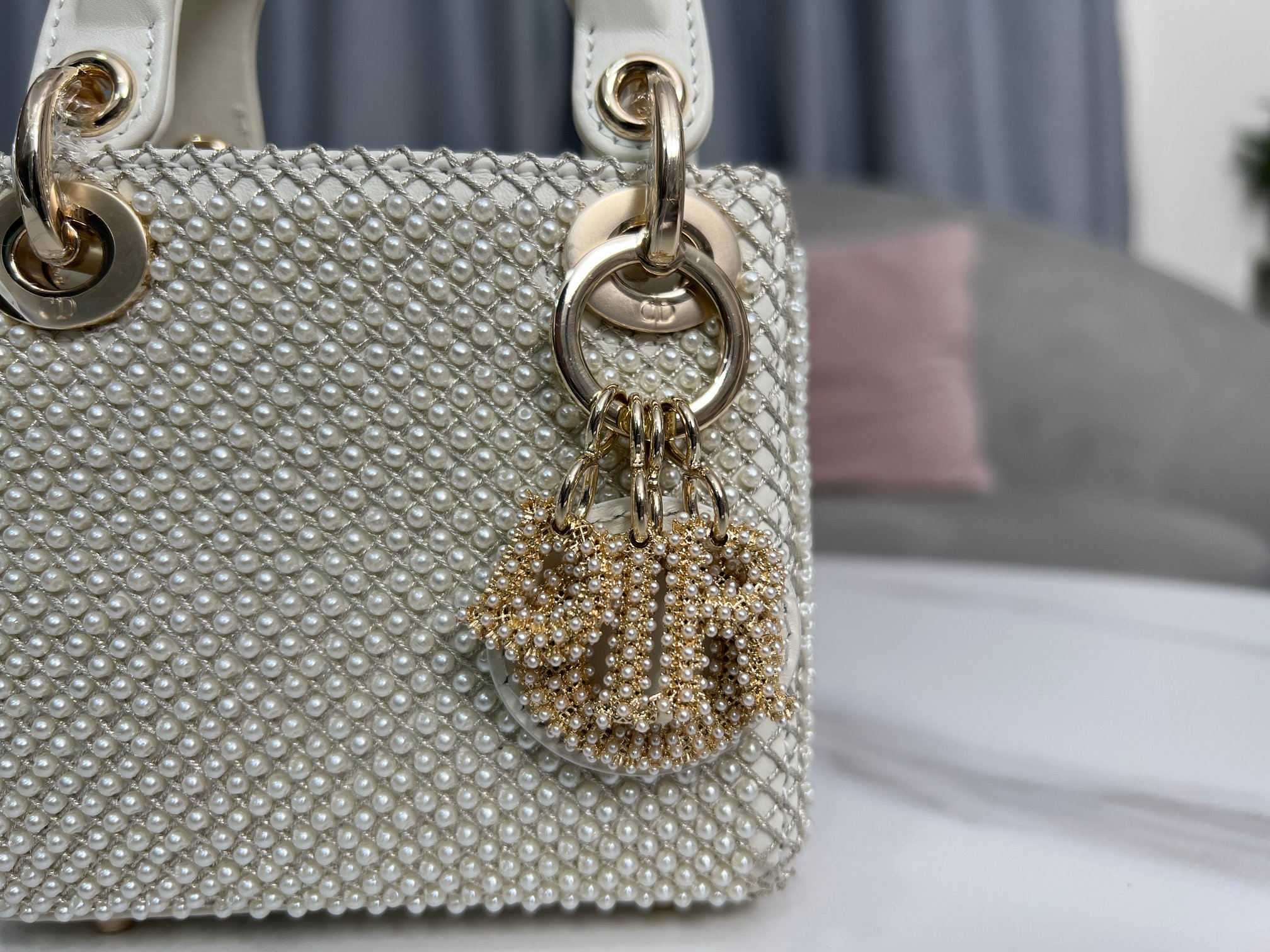 Lady Dior's ultra-mini embroidered limited edition pearls are lined with imported sheep tendons. They are carefully made by hand using milky whit