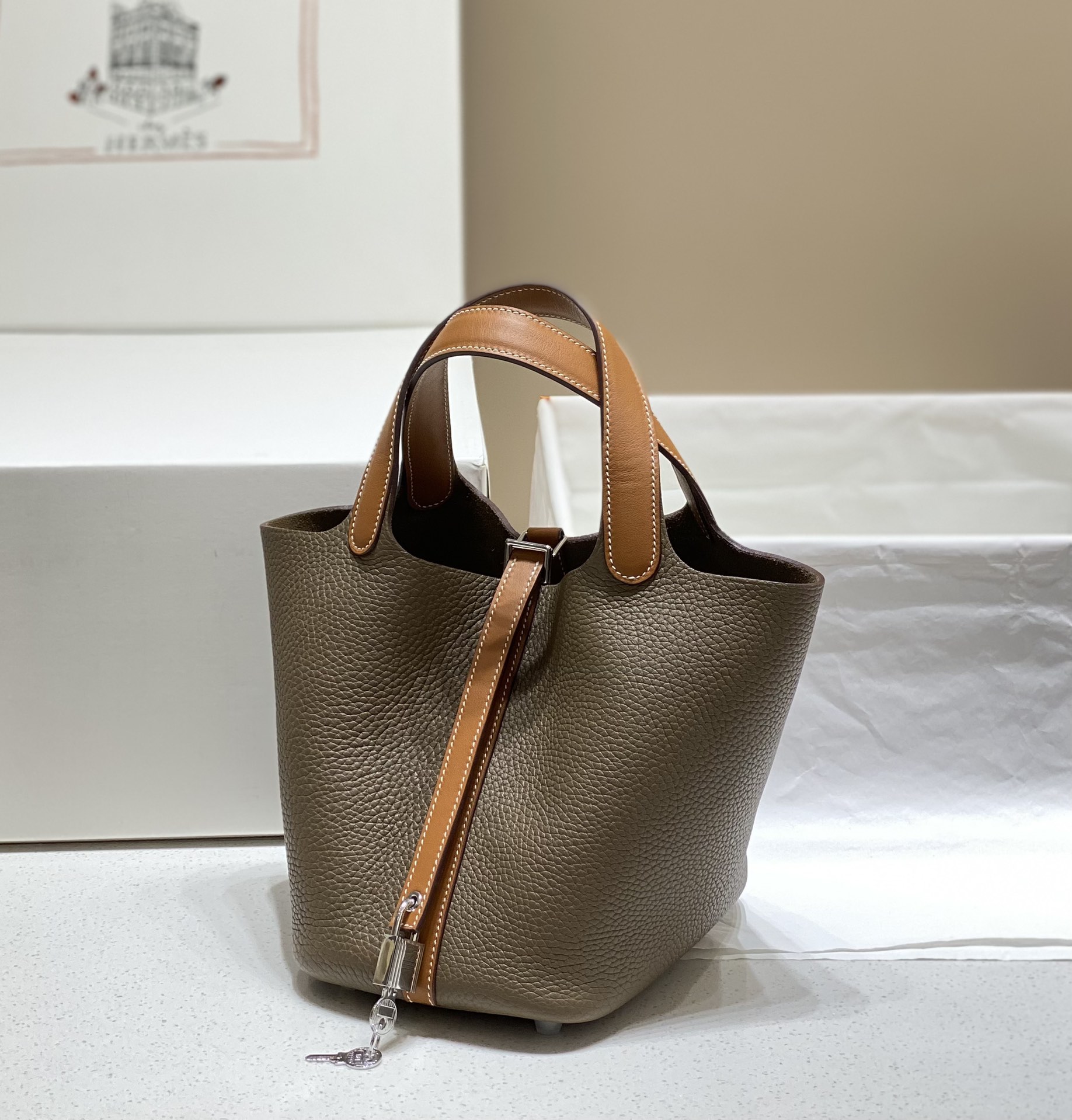 NO:698792,The latest color matching system, elephant gray/golden brown. If you know enough about Hermès, you will know that it is the only bucket-style bag from Hermès~ The classic color matching design adds a lot of highlights to the low-key vegetable basket, and the charm is instantly increased a hundred times - - Hermès vegetable basket, hand-sewn version, Togo wax thread, in stock 18Cm, Hermes, hermes, Hermes,19860909最新拼色系  大象灰/金棕色 如果对爱马仕足够了解就会知道 是爱马仕唯一一款水桶式包袋～ ‘’经典拼色设计给低调菜篮增添不少亮点 魅力感瞬间提升百倍 - - 爱马仕菜篮子 手工缝制版 Togo 蜡线 现货18Cm,爱马仕,hermes,Hermes,,Bag