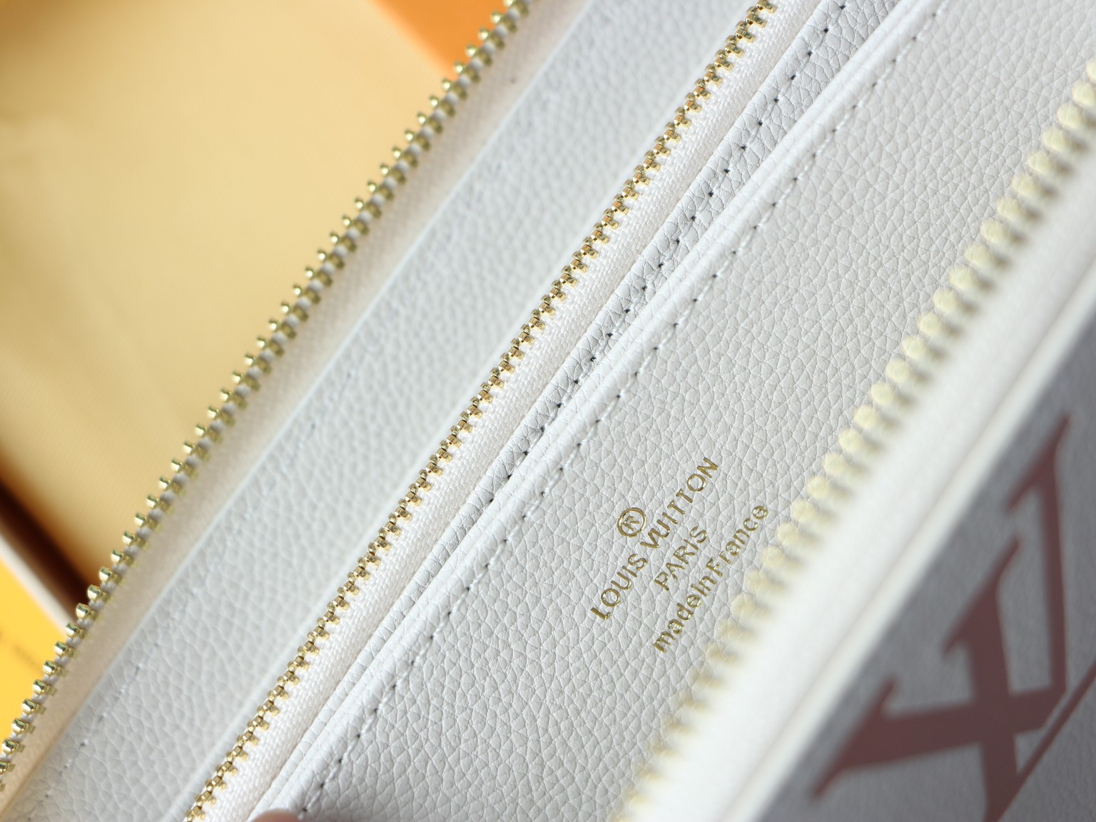 Leather wallet zipper and stitching close up