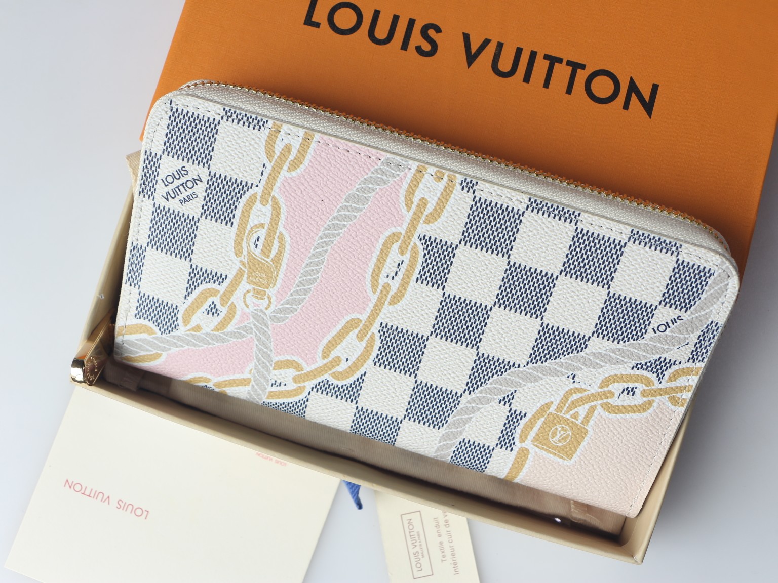 Person holding a long zipper leather wallet