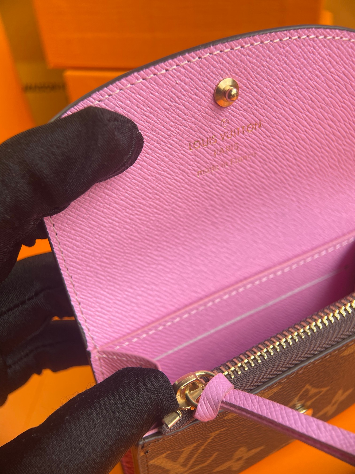 Person holding a leather bifold wallet