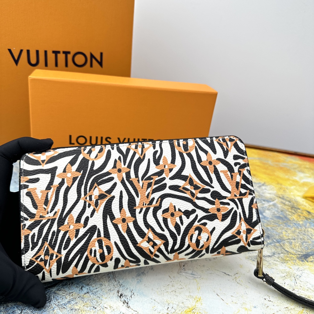 Zip around wallet held in hand, demonstrating size.