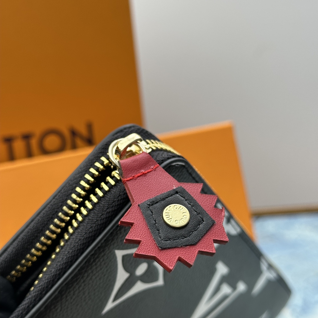 Close-up of the zipper closure on a long leather wallet