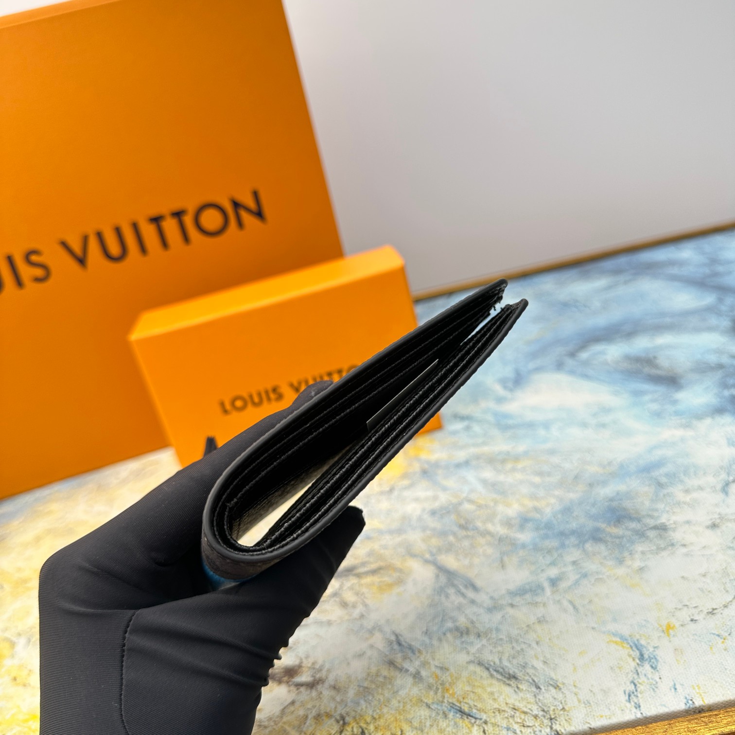 Men's leather bifold wallet in hand