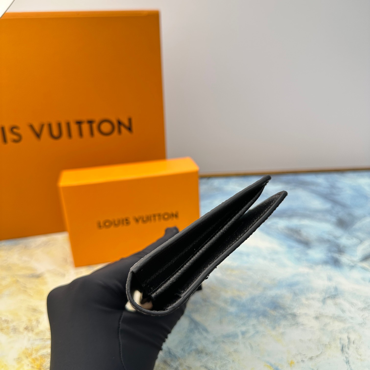 Side profile of the leather bifold wallet, showing its slim design.