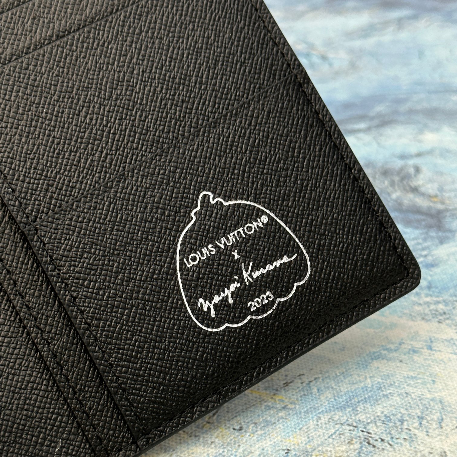 Leather bifold wallet presented in a gift box.
