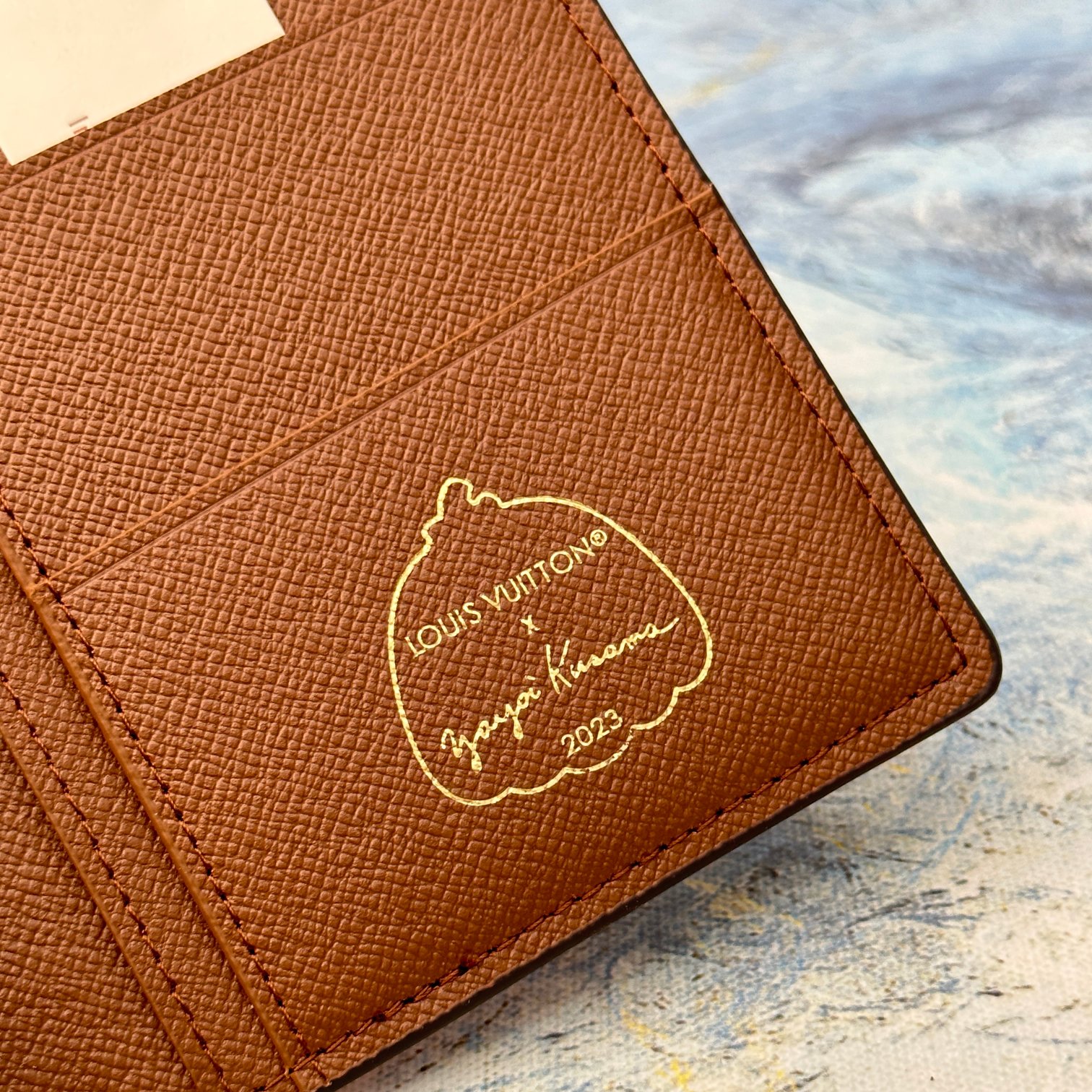 Leather bifold wallet in use.