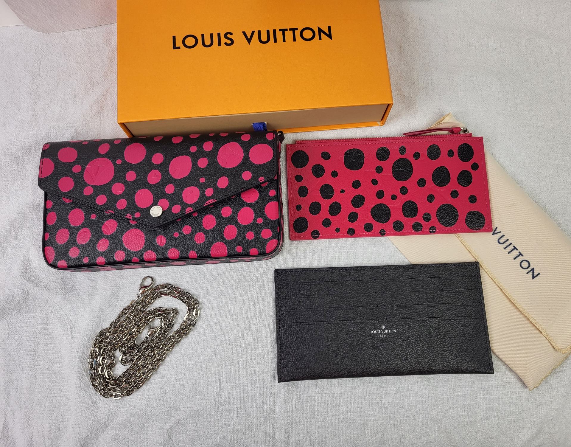 Louis Vuitton x Yayoi Kusama wallet in hand