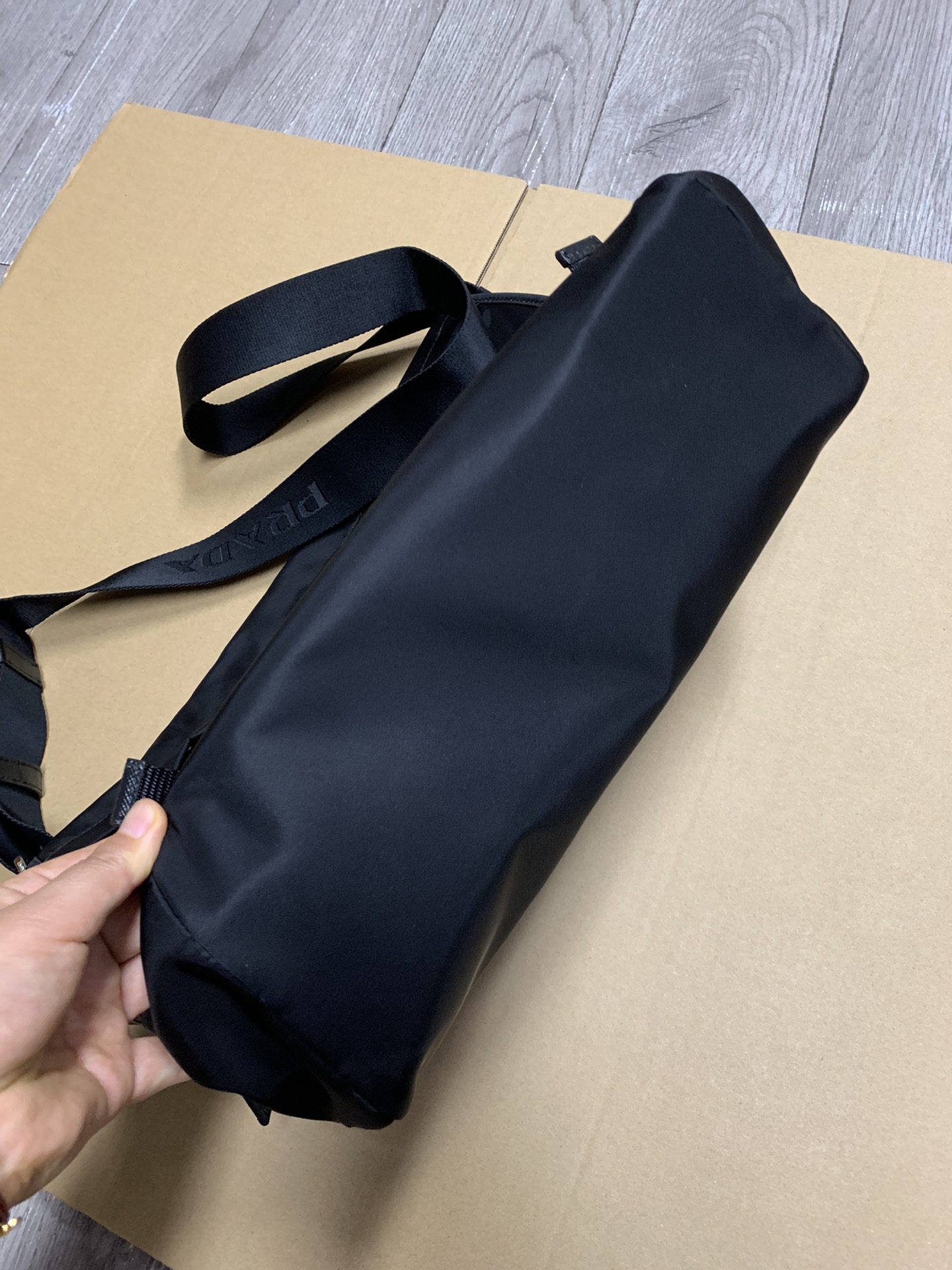 PRADA's latest messenger bag, made of original parachute waterproof fabric inside and out, silver brushed hardware, long adjustable nylon shoulde