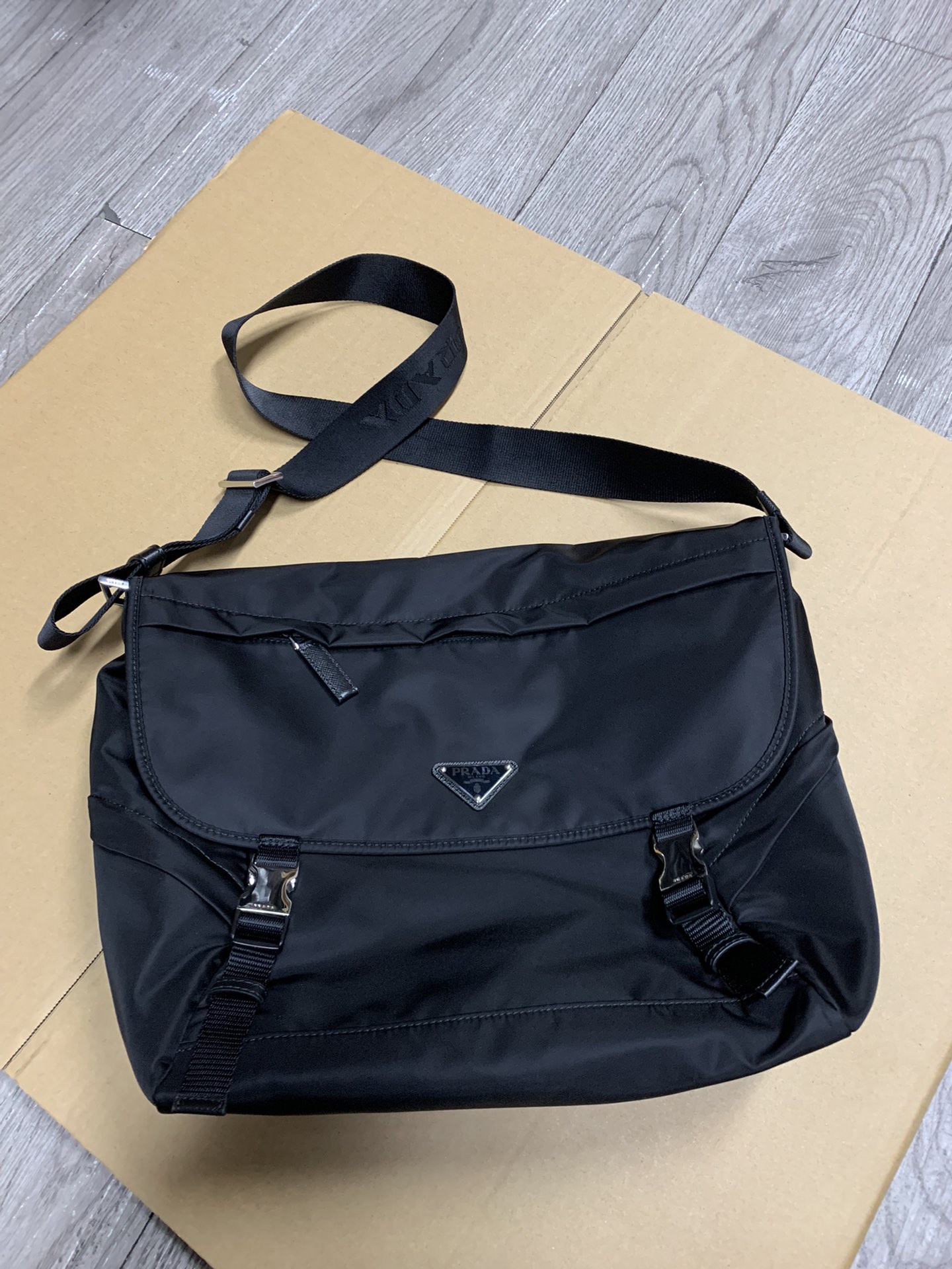 PRADA's latest messenger bag, made of original parachute waterproof fabric inside and out, silver brushed hardware, long adjustable nylon shoulde