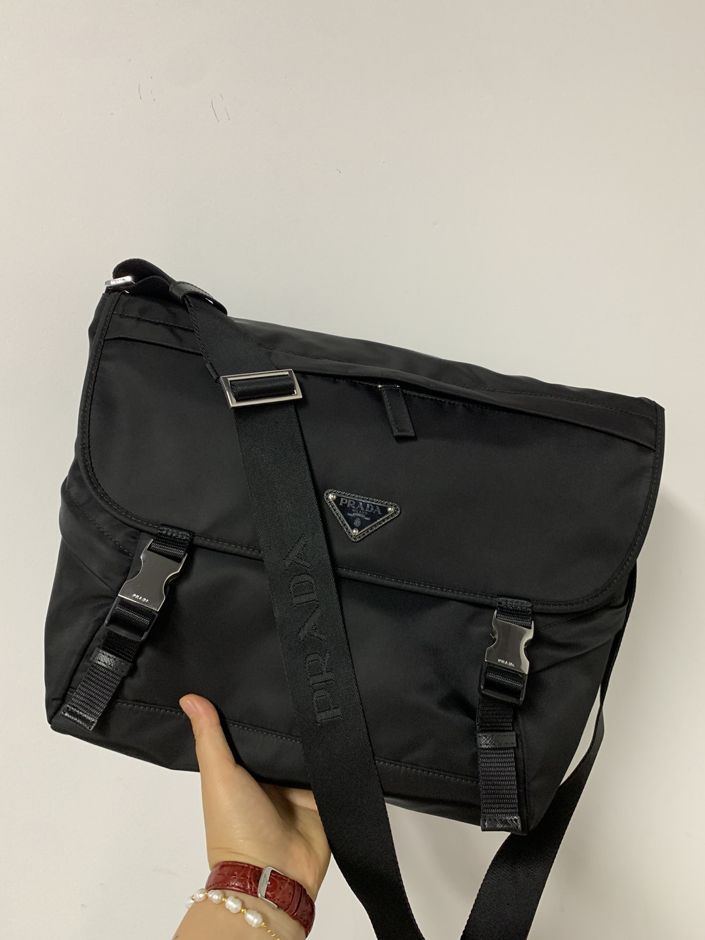 PRADA's latest messenger bag, made of original parachute waterproof fabric inside and out, silver brushed hardware, long adjustable nylon shoulde