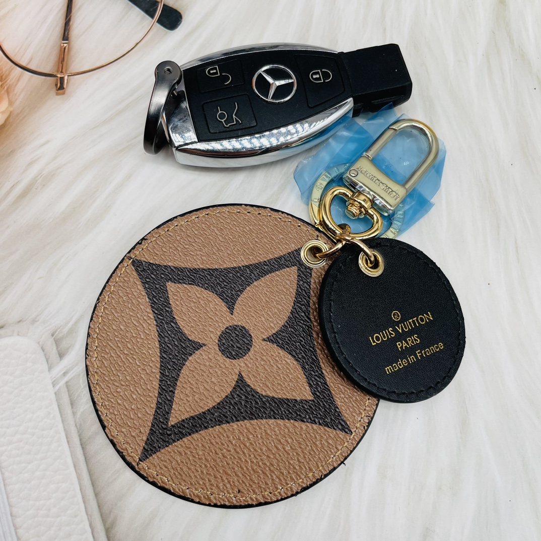 Classic round leather keychain attached to a bag