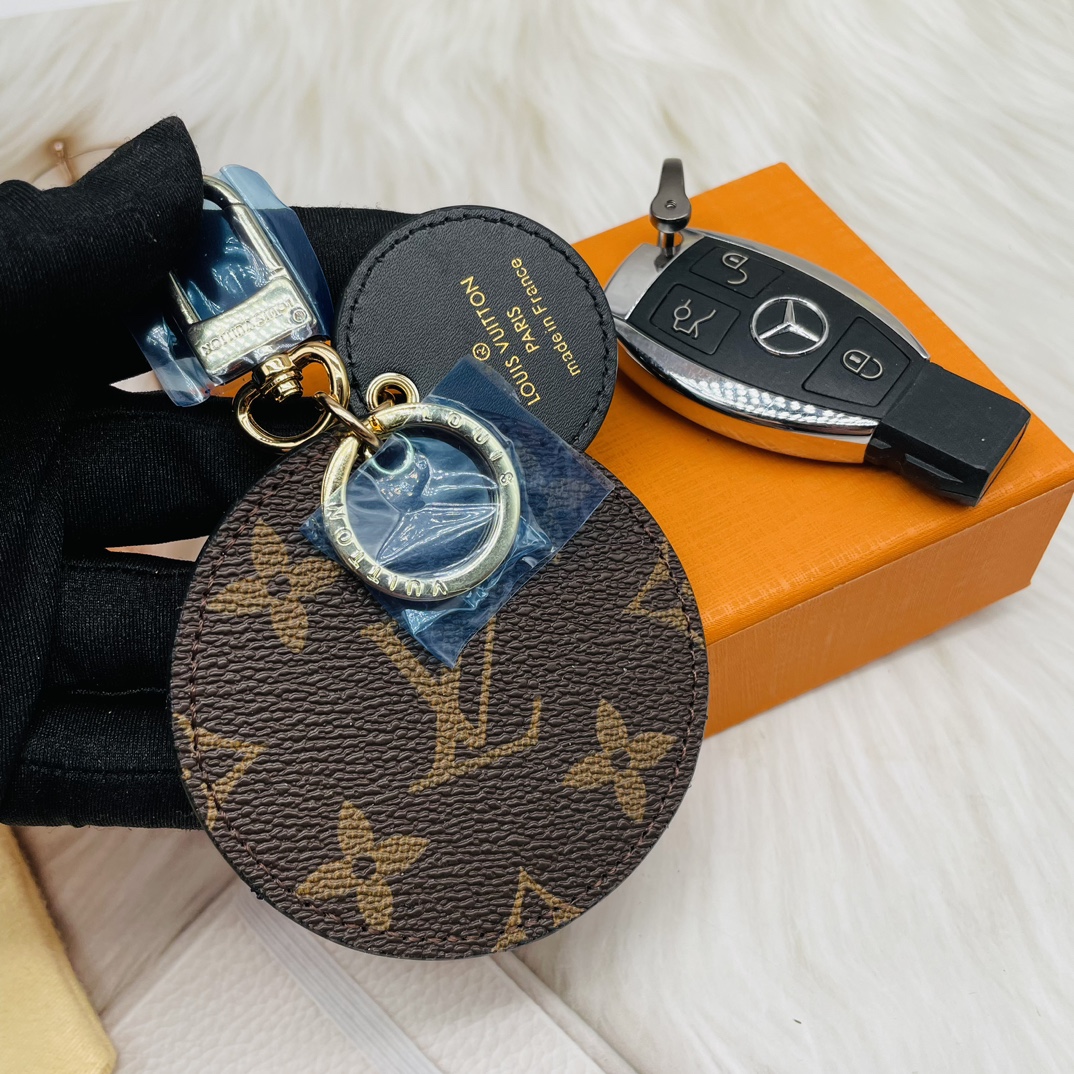 Classic round leather keychain held in hand