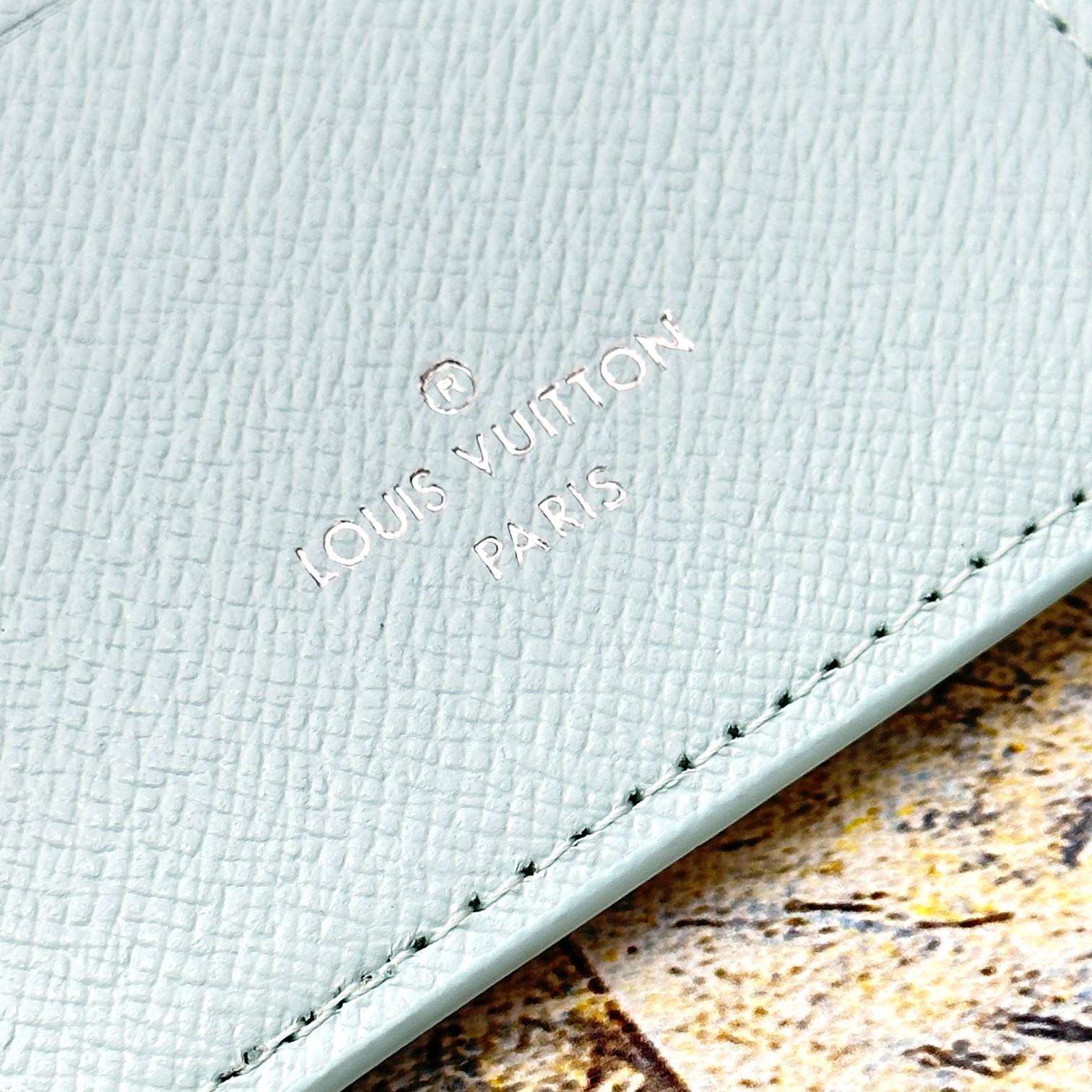 Close-up of stitching detail on a leather bifold wallet