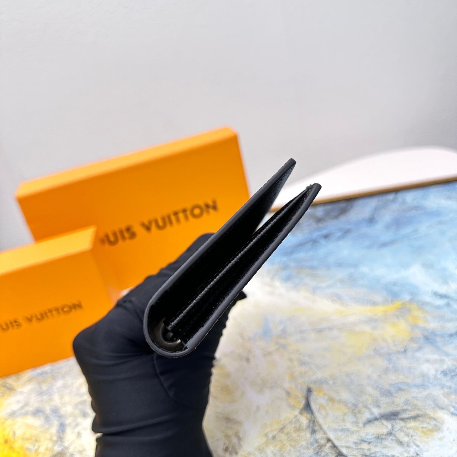 Leather bifold wallet held in hand