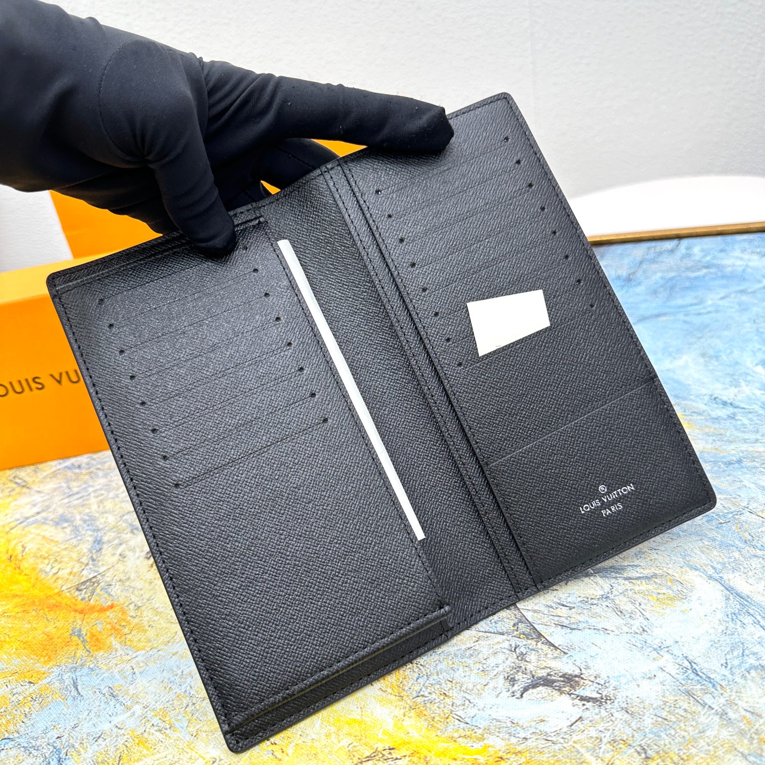 Close-up of stitching on a leather bifold wallet