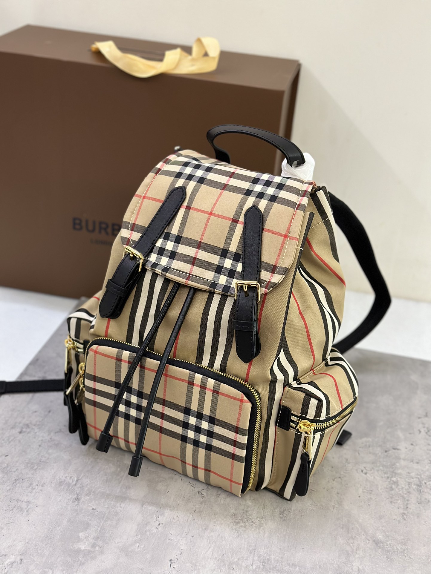 Burberry B Medium Vintage Stripe and Cowhide Military Backpack, crafted from plaid cotton fabric, decorated with topstitched cowhide trim, 3 zipp