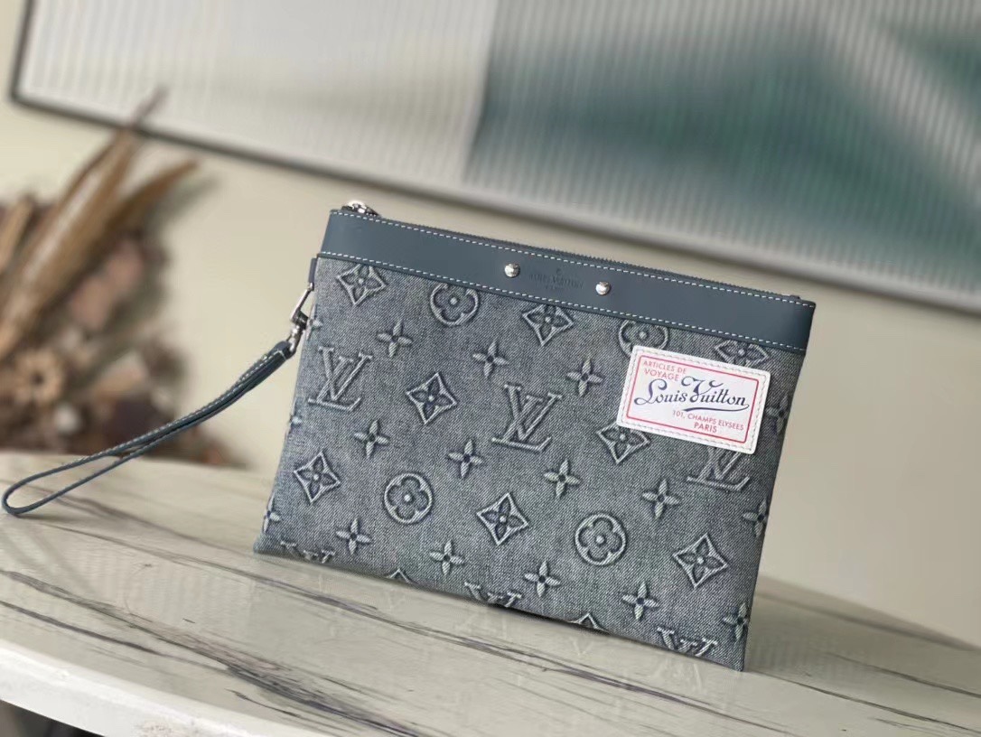 This Pochette To-Go pouch is crafted from Monogram Washed Denim canvas - Bag