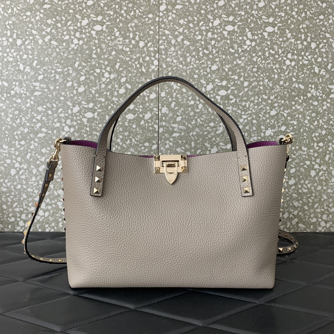Valentino Garavani calfskin tote bag, decorated with iconic Rockstud decoration, roll-top handle, different contrasting styles on the inside and