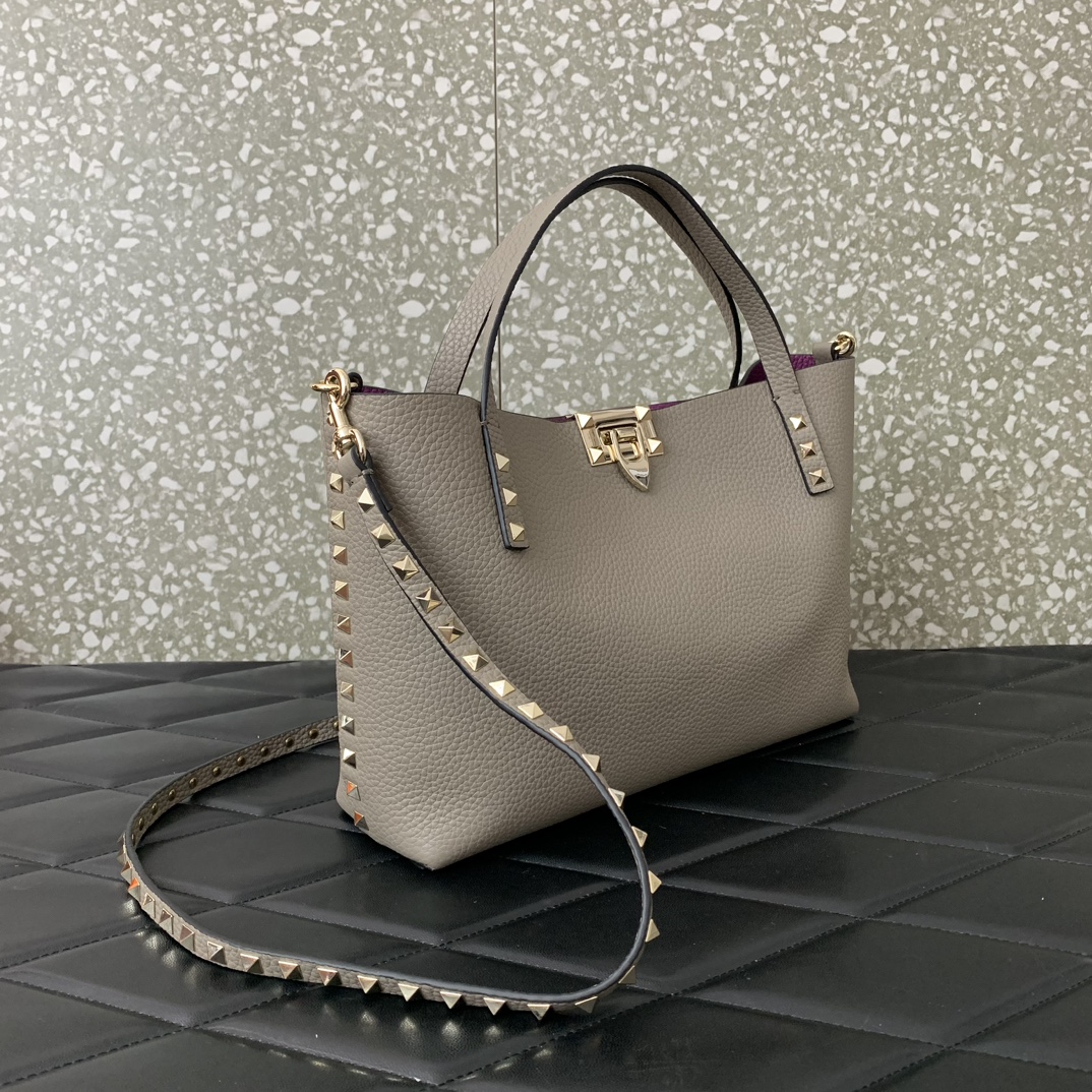 Valentino Garavani calfskin tote bag, decorated with iconic Rockstud decoration, roll-top handle, different contrasting styles on the inside and