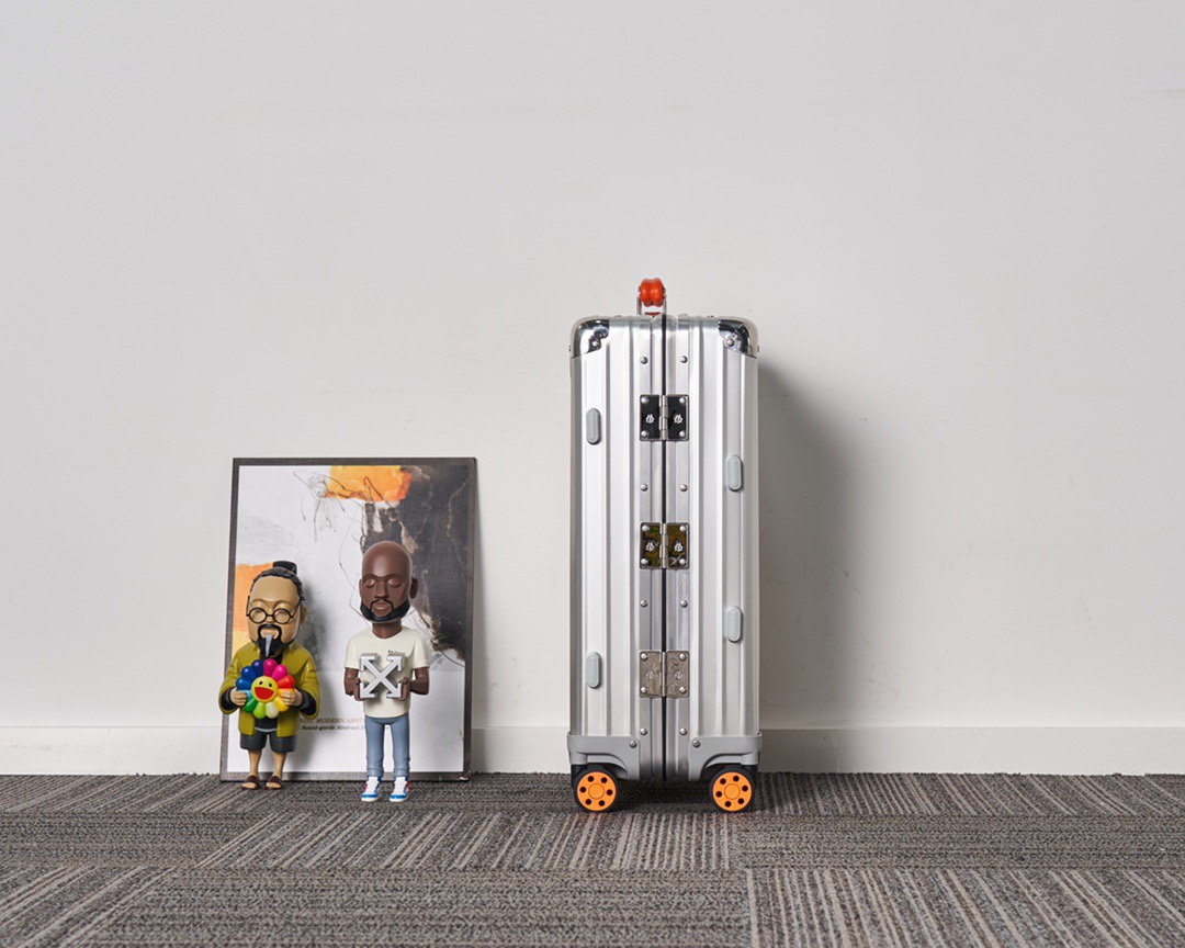 Rimowa suitcase Silver with orange handles travel