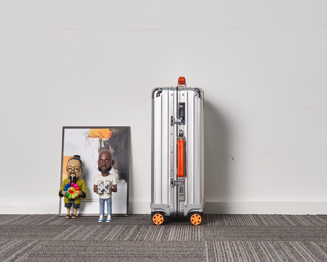 Rimowa suitcase Silver with orange handles travel