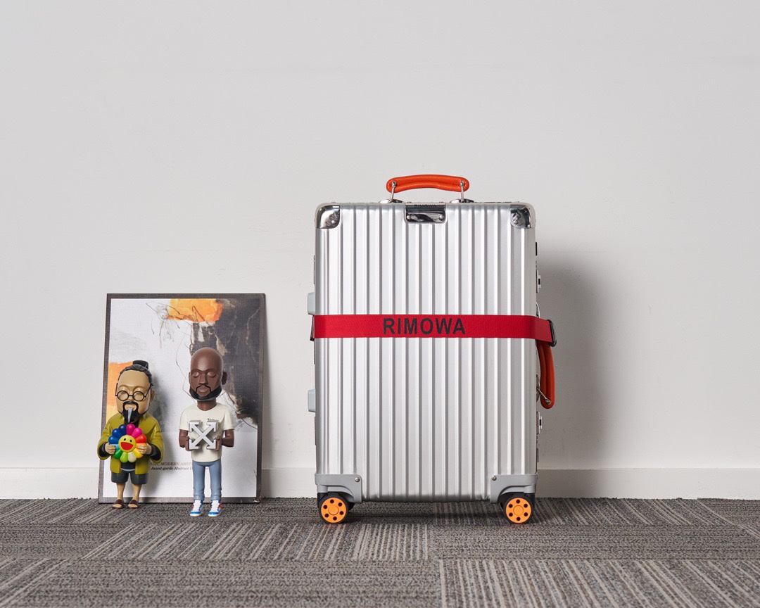 Rimowa suitcase Silver with orange handles travel