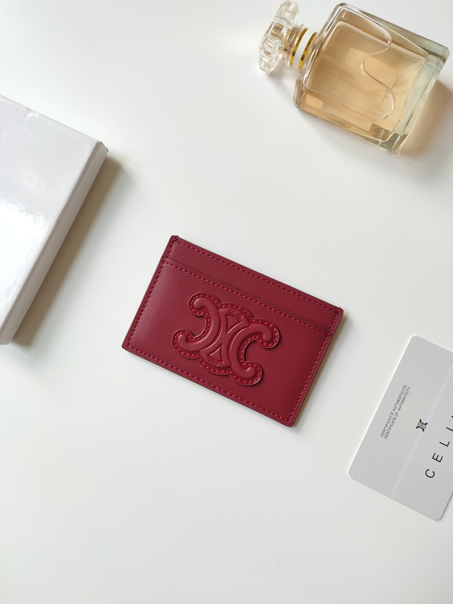 Celine Triomphe card holder Burgundy smooth calfskin leather with matching tone Triomphe logo embossment 7cm x 10 5cm
