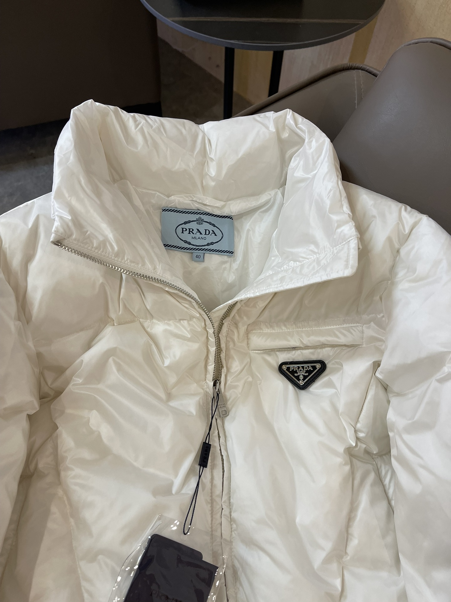 Prada triangle logo 90% white goose down short jacket in black, white, brown. Sizes 38-44.-Big cat