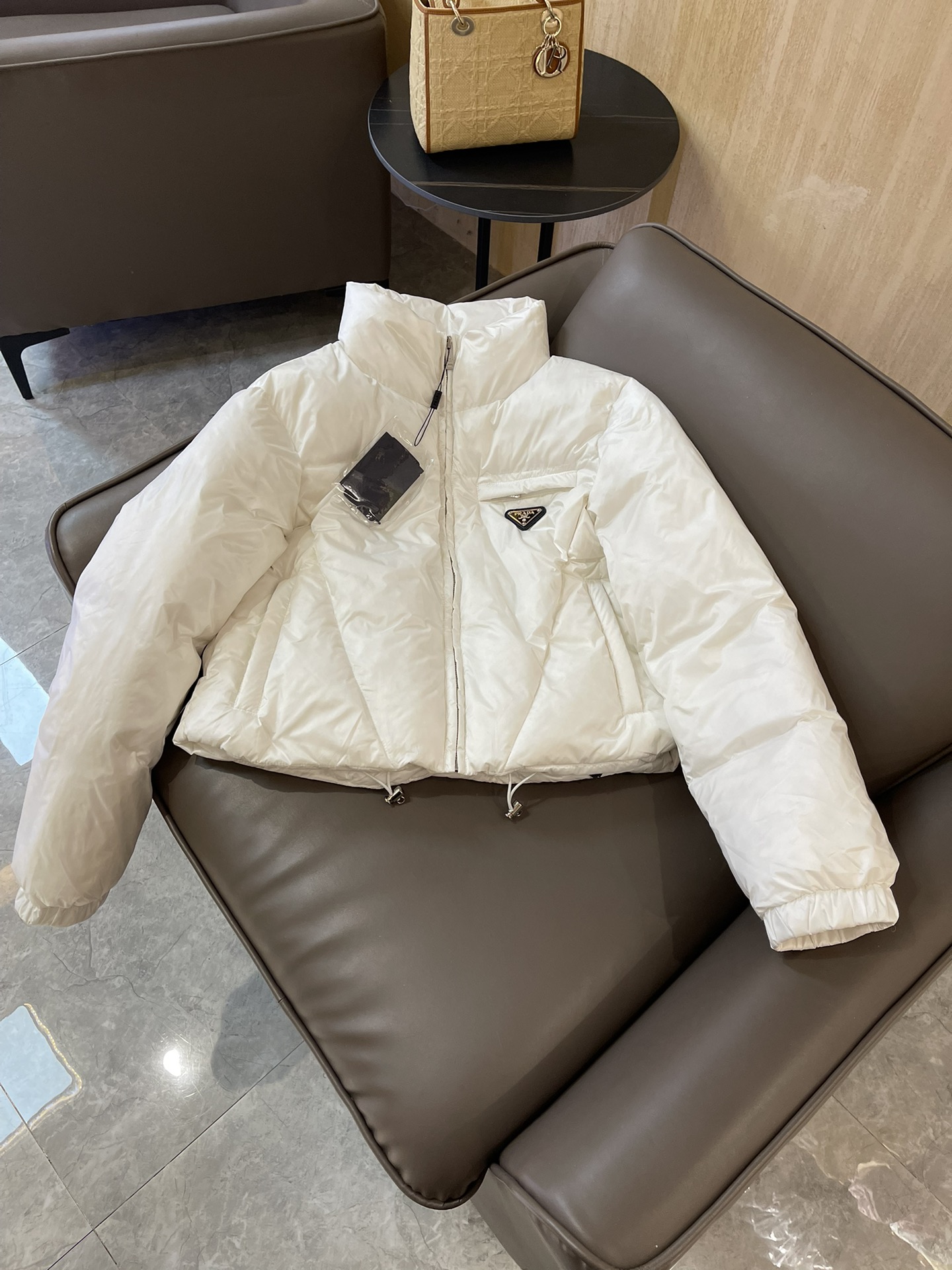 Prada triangle logo 90% white goose down short jacket in black, white, brown. Sizes 38-44.-Big cat
