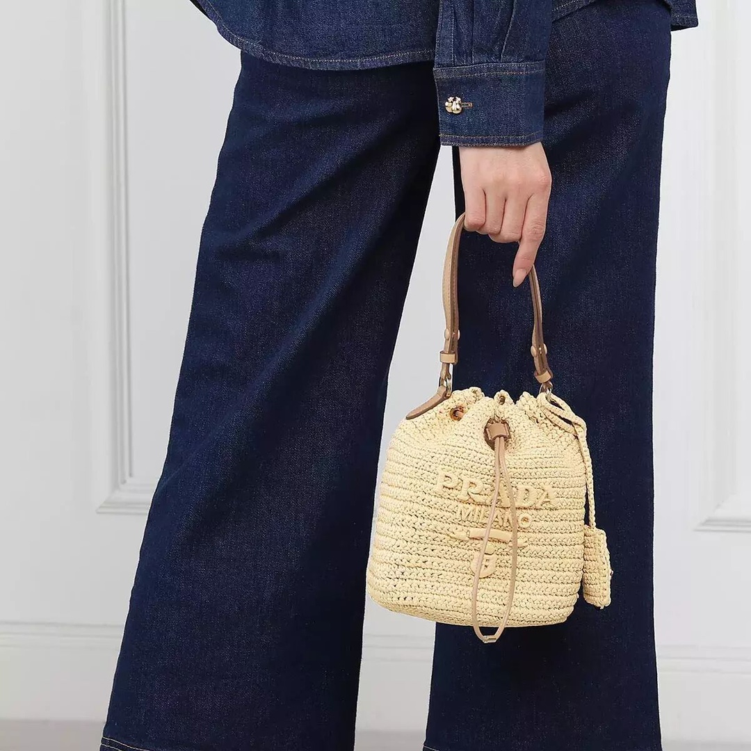 Prada Straw bucket, a must-have for vacation
