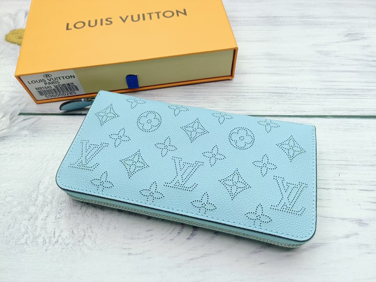 Person holding leather long wallet in hand