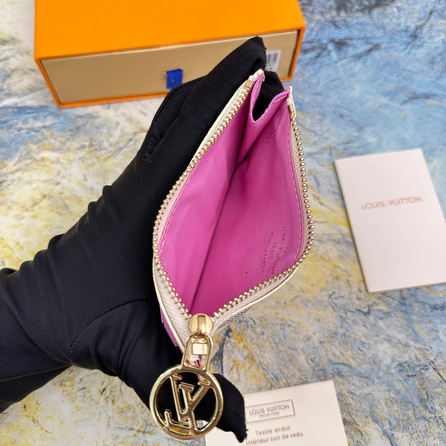 The leather wallet in a pocket, or being used at a shop.