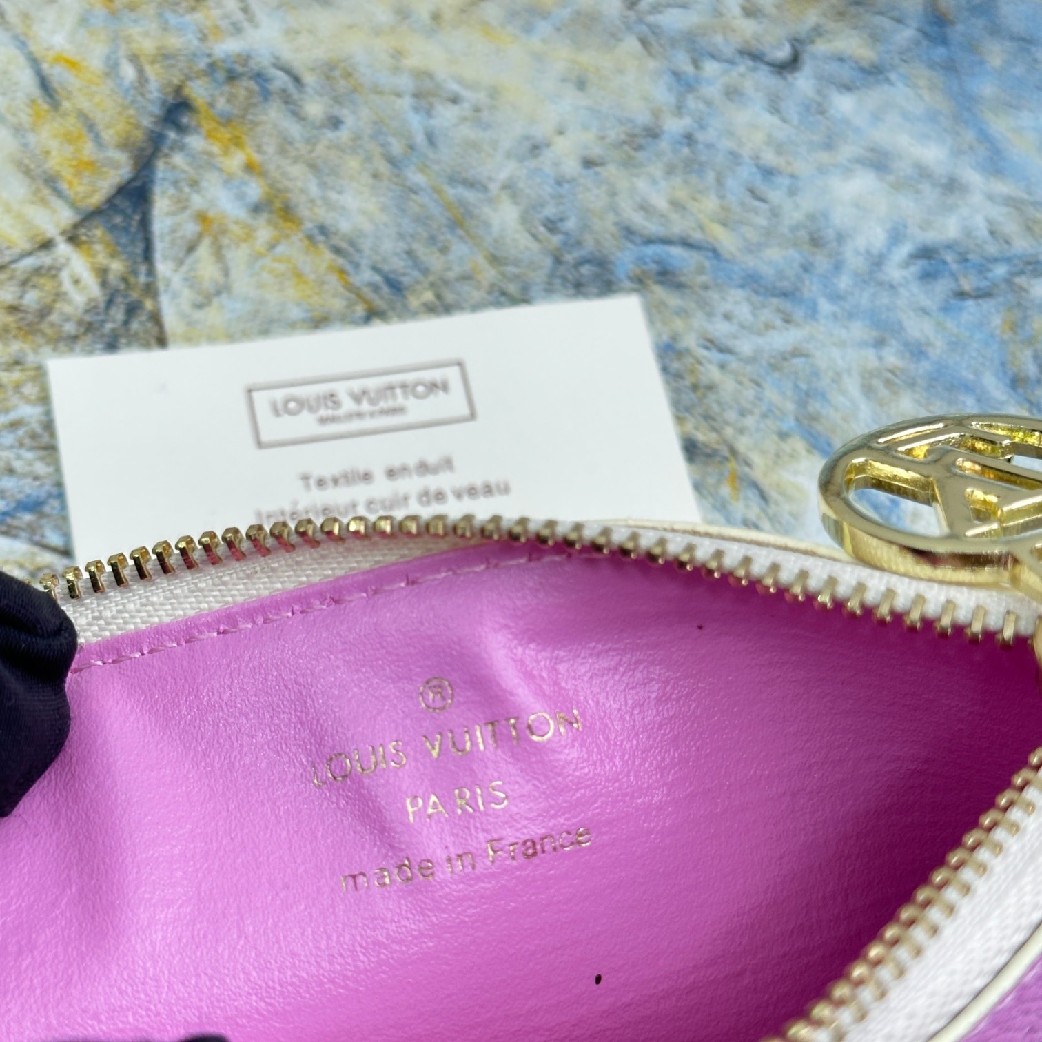 Close up of the leather wallet, showing the brand logo.