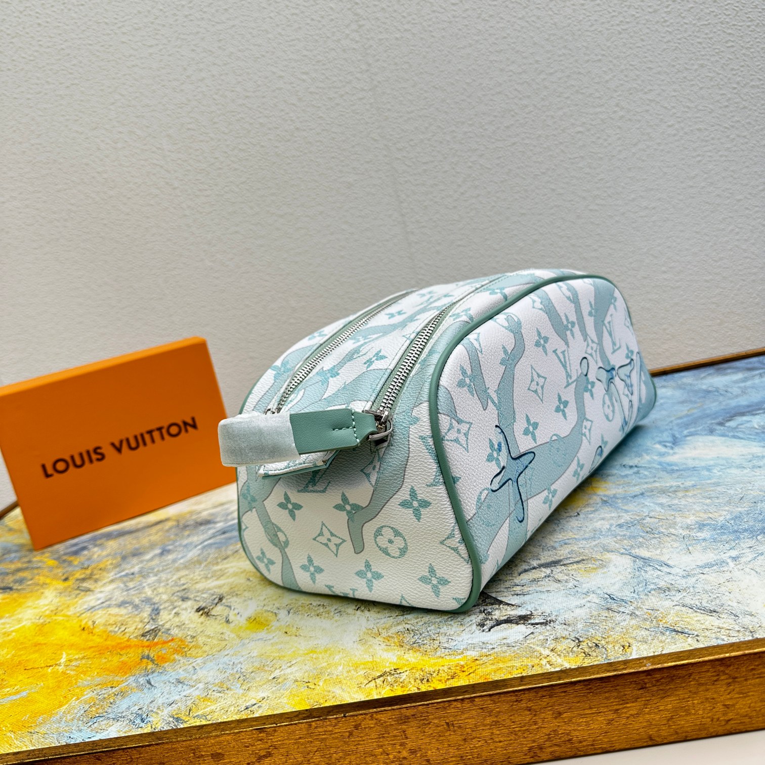 Leather wash bag side view, detailing the stitching and handle