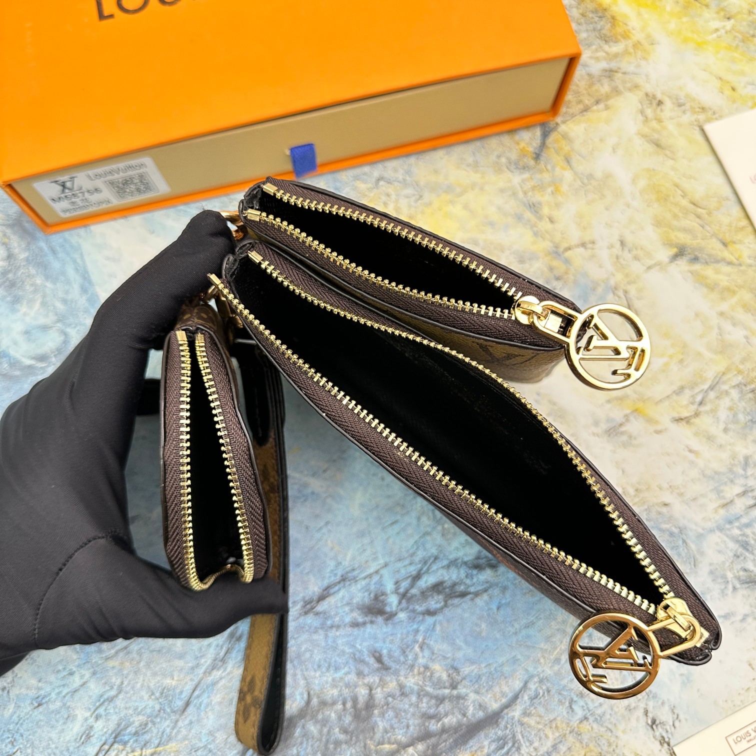 Close up of the leather wallet, showing the brand logo.